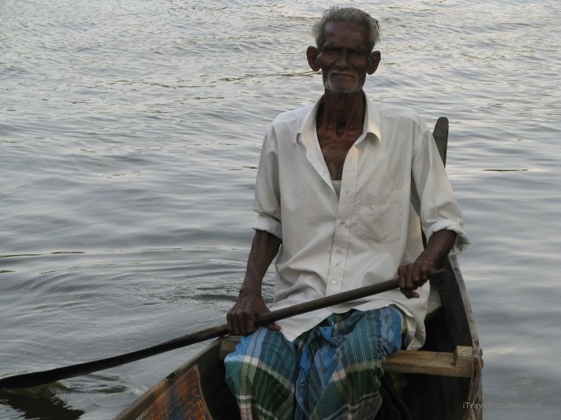 Keralan backwaters old man paddling