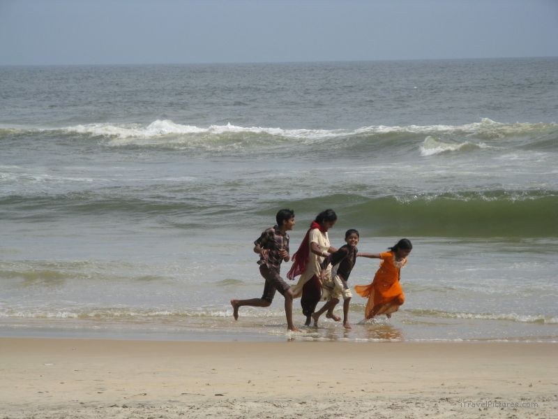 Varkala children running beach wave waves